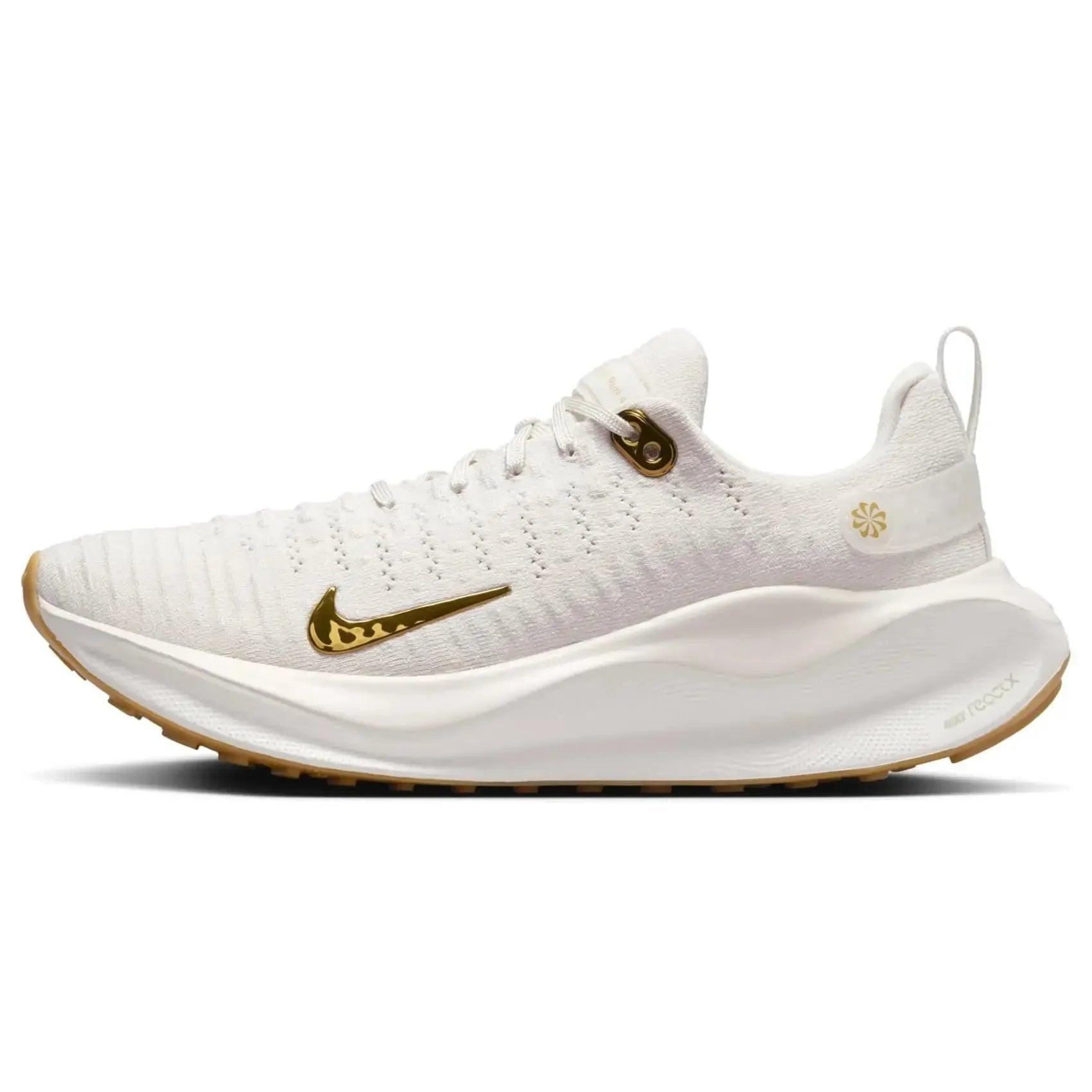 White women's running shoe with gold swoosh, breathable knit upper, and cushioned sole for comfort and style
