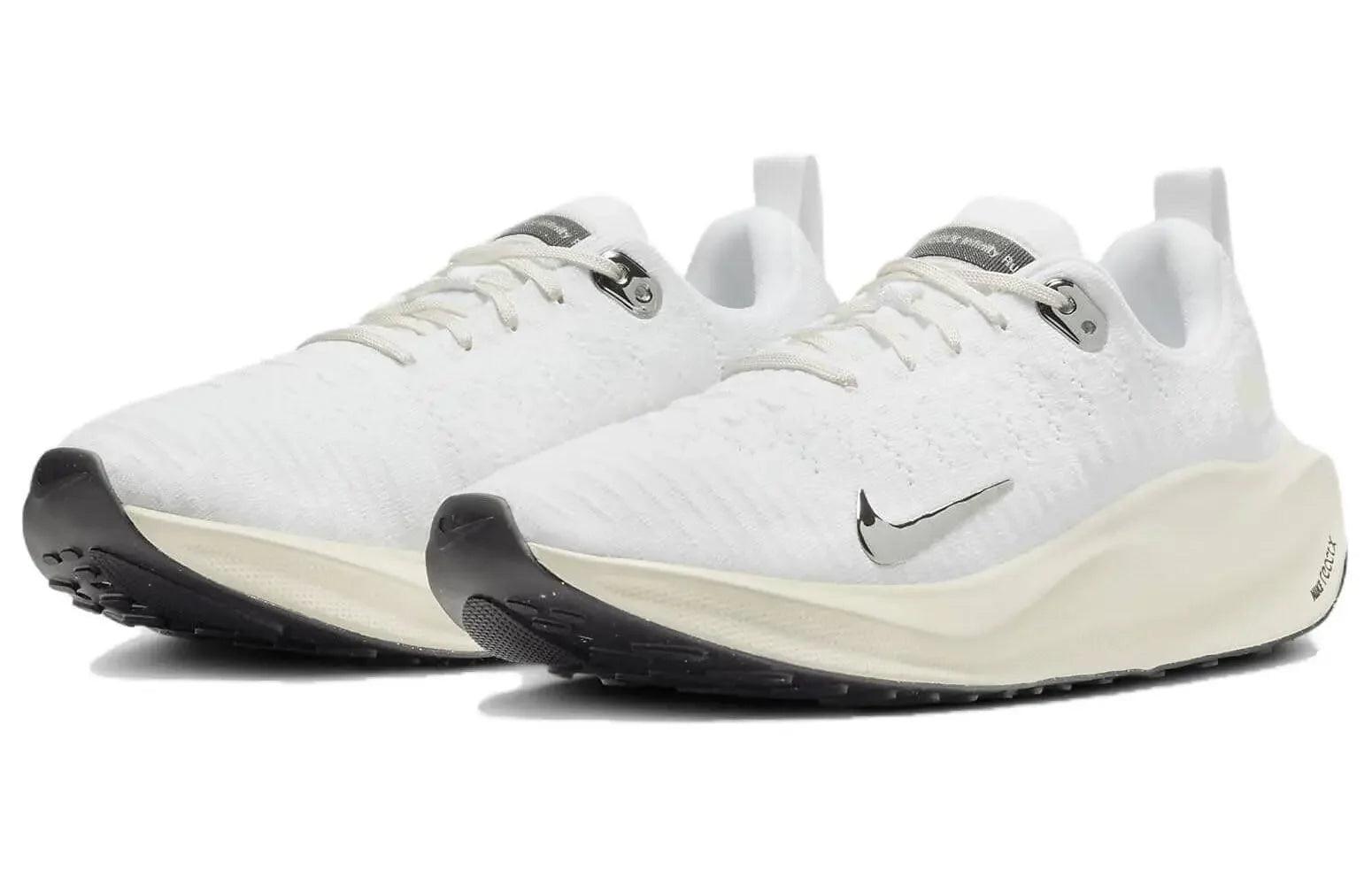 White Nike running shoes with black soles and silver swoosh, lightweight athletic sneakers for women