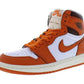 Orange and white Nike Air Jordan 1 high-top sneaker with classic design and Jumpman logo