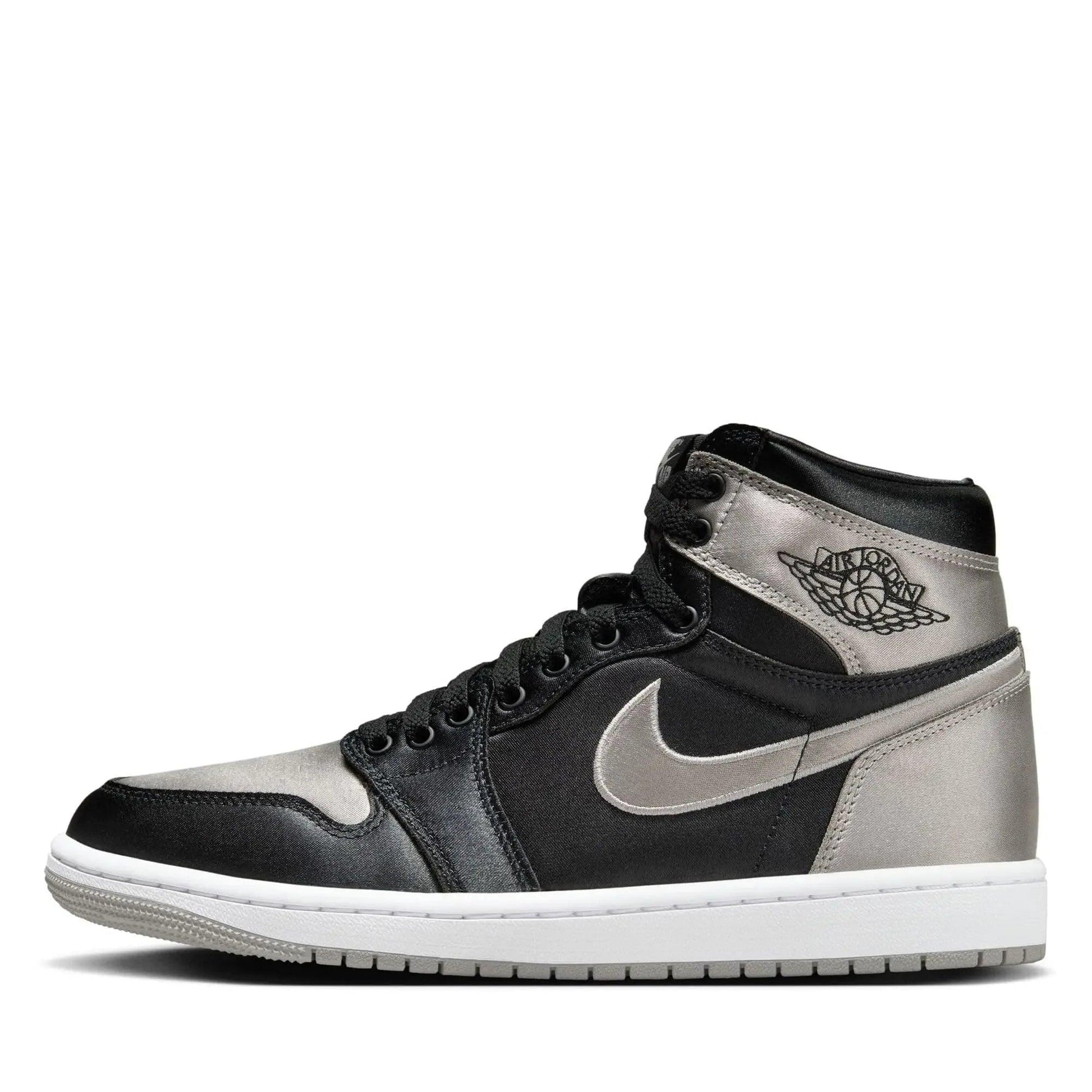 Black and silver high-top sneaker with Air Jordan logo and Nike swoosh, stylish women's fashion footwear
