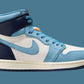 Women's high-top sneaker in light blue, white, and navy with Nike swoosh, stylish fashion footwear