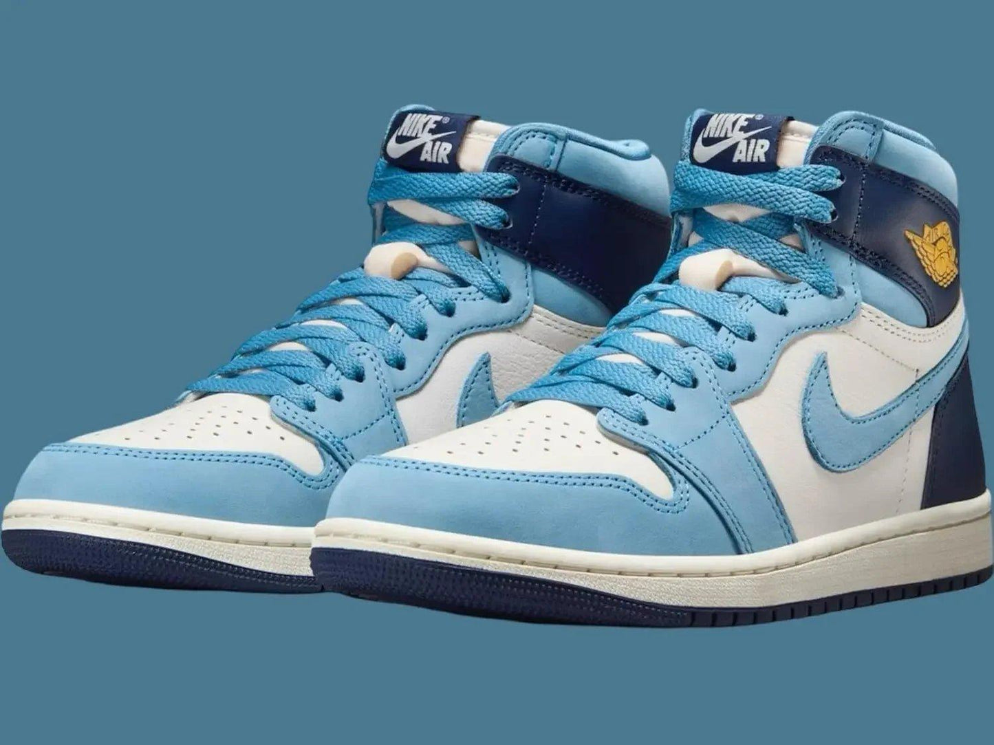 Nike Air Jordan 1 high-top sneakers in light blue, white, and navy with gold wing logo, stylish women's fashion footwear
