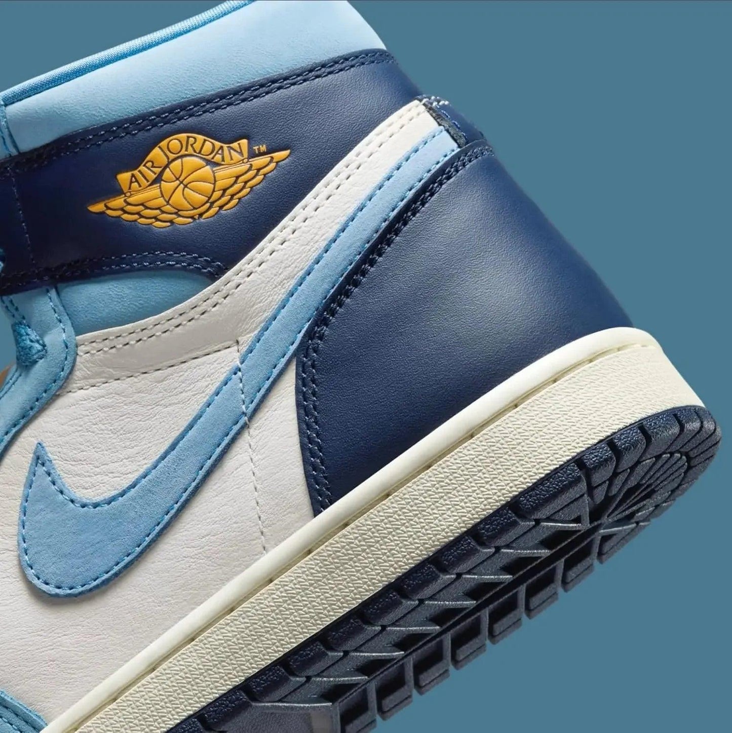 Air Jordan 1 sneaker in blue and white with gold winged logo, stylish women's fashion footwear