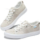 Beige canvas women's sneakers with white laces and frayed edges, stylish casual footwear for everyday wear