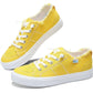 Bright yellow women's canvas sneakers with white laces and frayed edges, stylish casual footwear