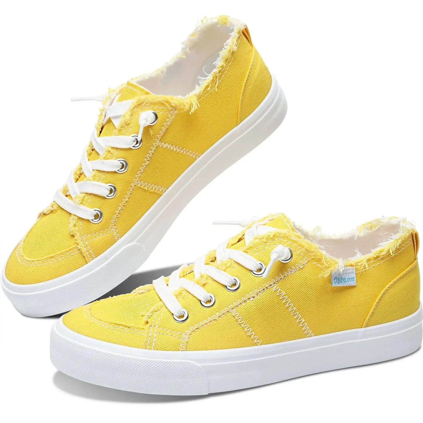 Bright yellow women's canvas sneakers with white laces and frayed edges, stylish casual footwear
