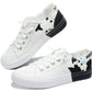 White canvas sneakers with black cow print, frayed edges, and two-tone soles for women's fashion