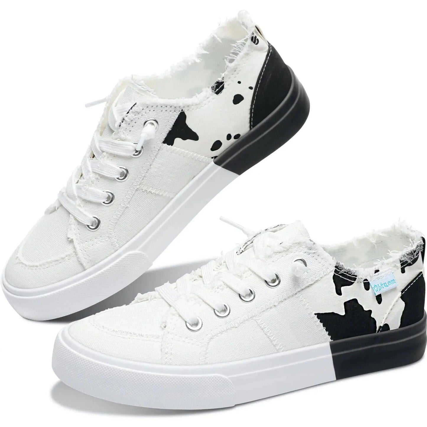 White canvas sneakers with black cow print, frayed edges, and two-tone soles for women's fashion