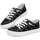 Black canvas sneakers with white laces and distressed details, women's fashion footwear