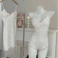 White floral lace trim camisole and shorts set on mannequin, matching hanging sleepwear, cozy bedroom style