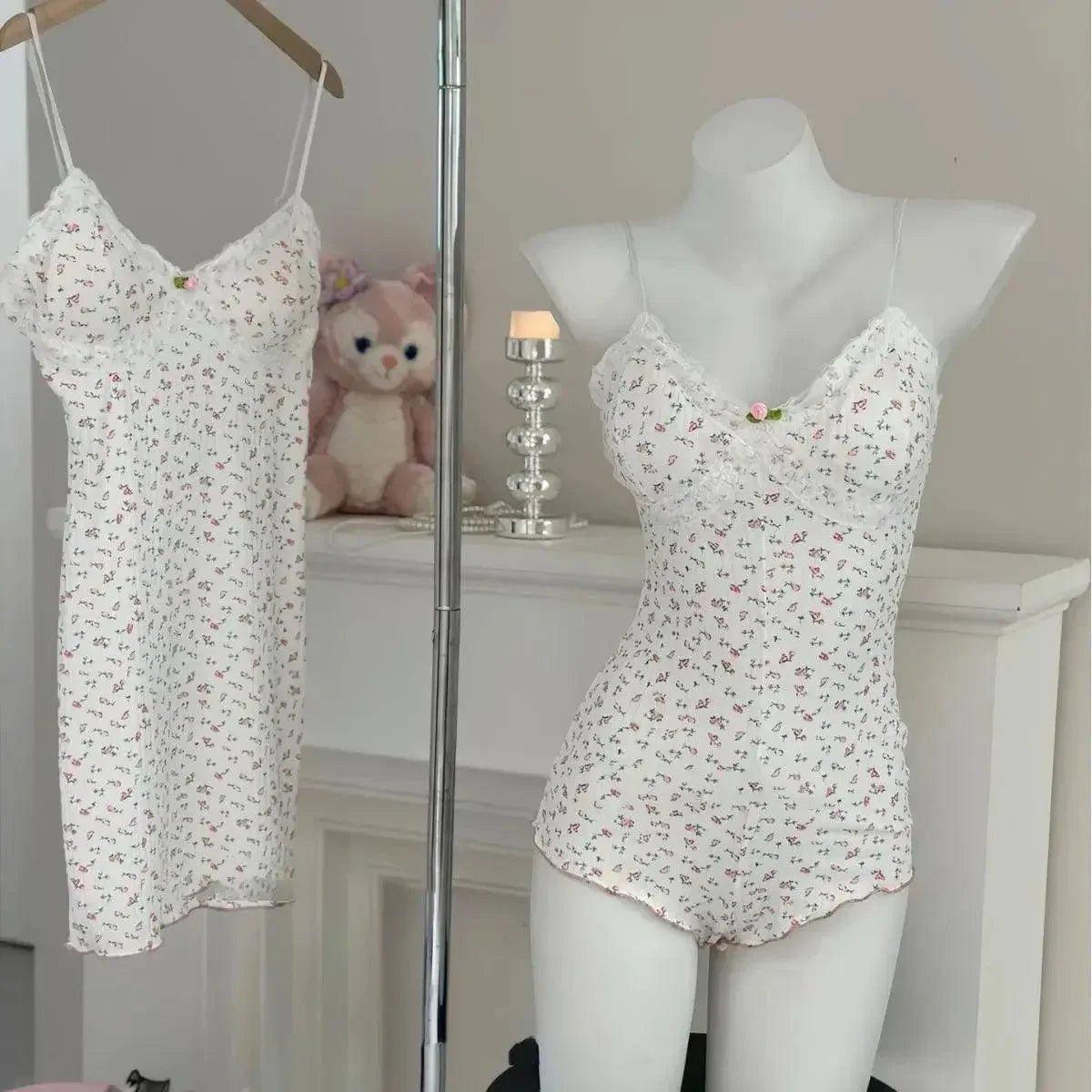 White floral lace trim camisole and shorts set on mannequin, matching hanging sleepwear, cozy bedroom style
