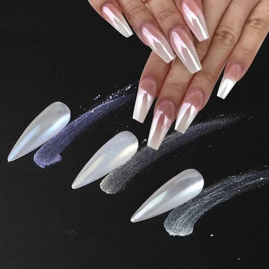 Glossy white stiletto press-on nails with iridescent finish, shown on hands and loose against black background