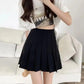 Black pleated mini skirt for women, paired with white crop top, casual fashion outfit