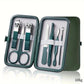 Green travel manicure set with nail clippers, scissors, tweezers, and files in compact case