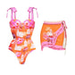 Vibrant orange and pink floral one-piece swimsuit with matching wrap skirt, perfect for beach fashion