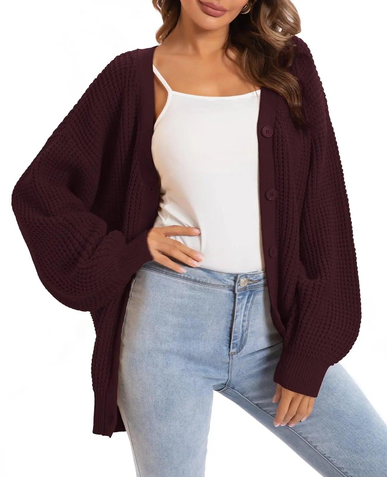 Woman wearing burgundy waffle knit cardigan over white top with light wash jeans, stylish fall fashion