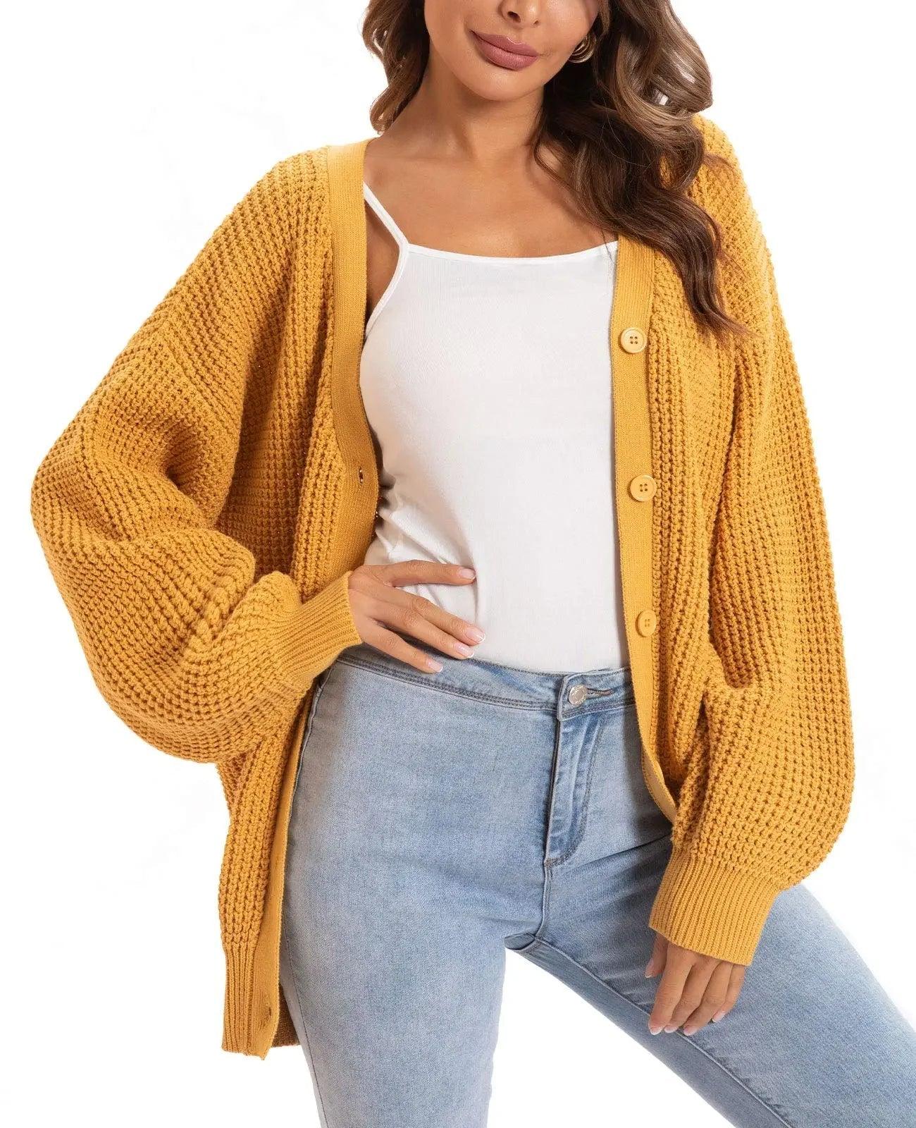 Mustard yellow knitted cardigan with buttons, styled over white top and jeans for women's fashion