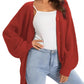 Red chunky knit cardigan with buttons, worn over white top and light wash jeans, women's fashion