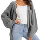 Gray knit cardigan with buttons, worn over white top and light wash jeans, women's fashion