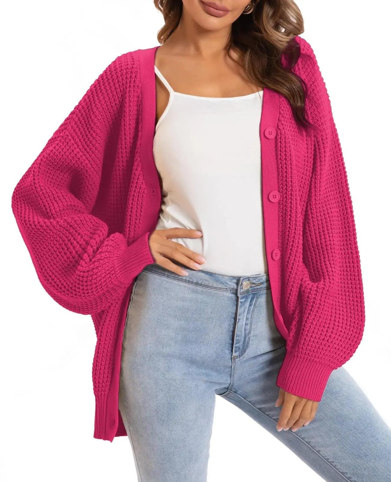 Pink knit cardigan sweater with buttons, worn over white top and jeans for women's fashion