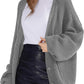 Grey oversized knit cardigan with buttons, styled with white top and black leather mini skirt for women's fashion