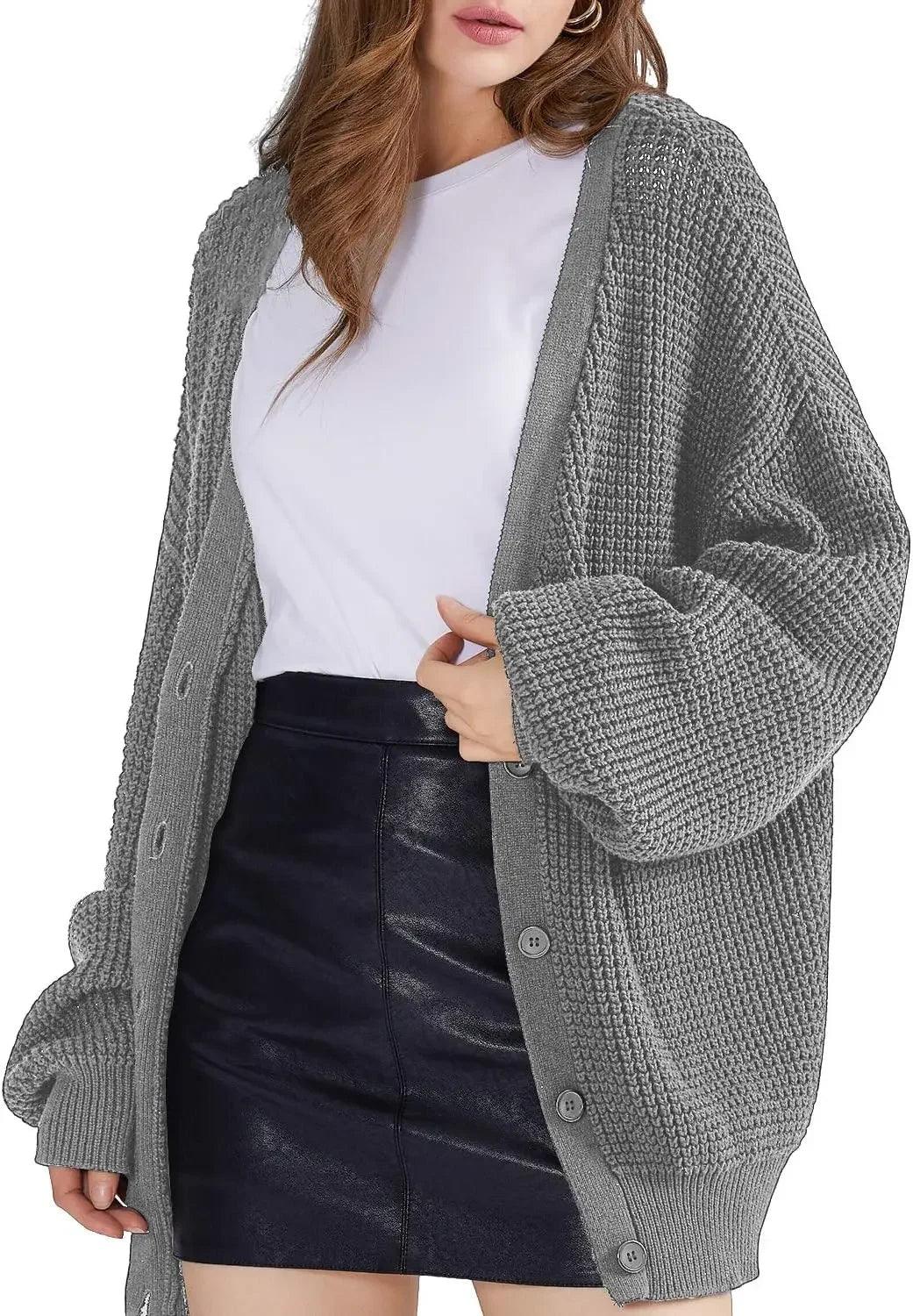Grey oversized knit cardigan with buttons, styled with white top and black leather mini skirt for women's fashion
