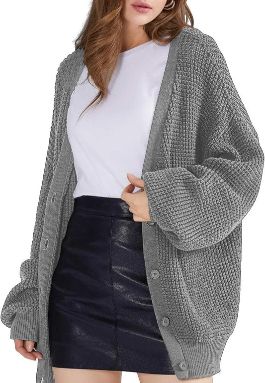 Grey oversized knit cardigan with buttons, styled with white top and black leather mini skirt for women's fashion