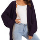 Woman wearing cozy navy waffle knit cardigan over white top with light wash jeans, stylish fall fashion