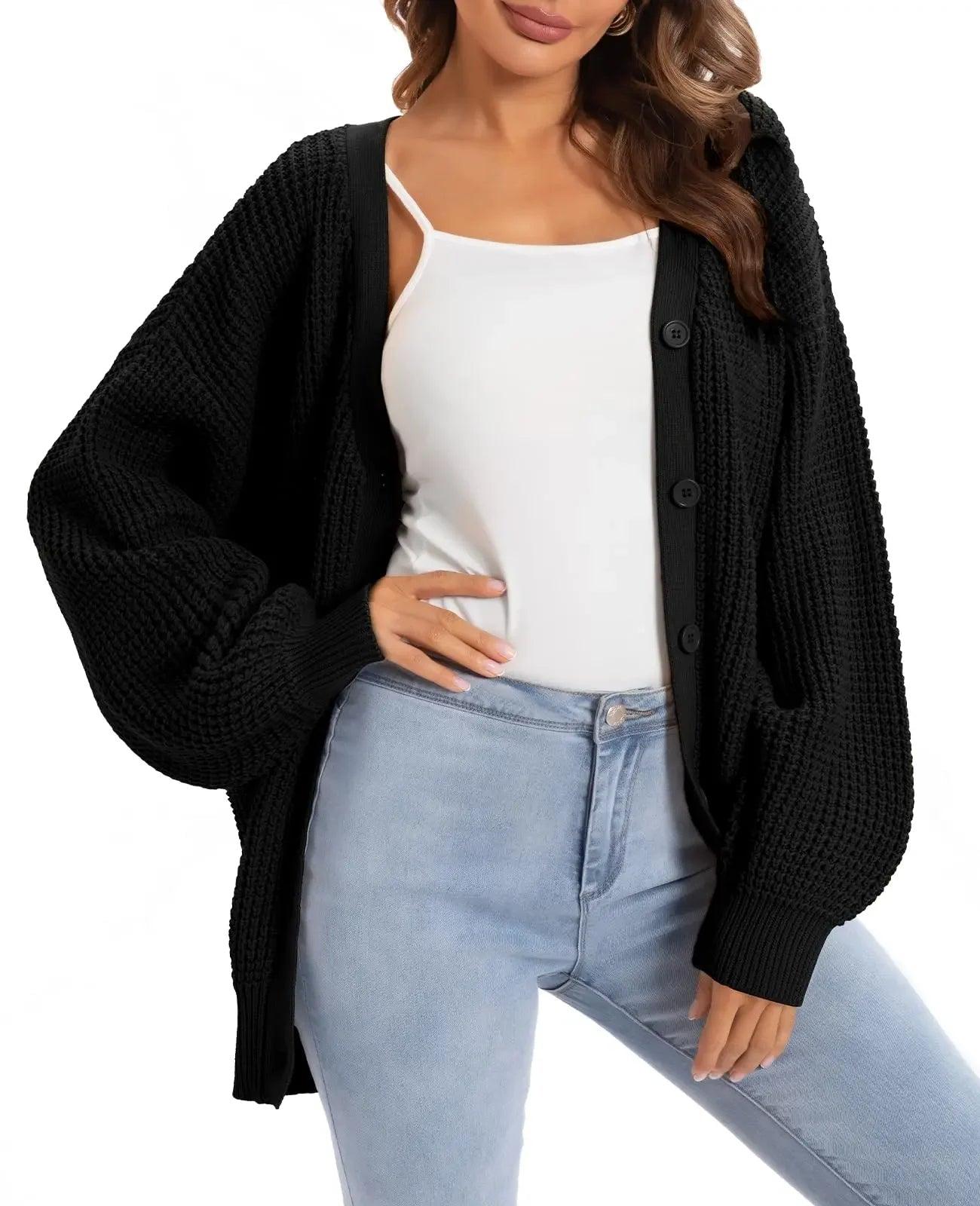 Woman wearing black knit cardigan over white top with light blue jeans, stylish fashion outfit