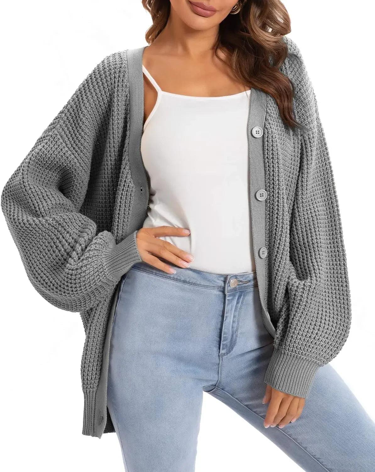 Gray knitted cardigan with buttons, worn over white top and light blue jeans, women's fashion