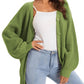 Green knitted cardigan with buttons, worn over white top and light jeans, women's fashion