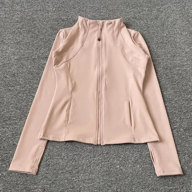 Blush pink women's zip-up athletic jacket with long sleeves and side pockets, ideal for fitness and casual wear