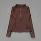 Brown women's zip-up athletic jacket with long sleeves and side pockets, stylish fitness wear