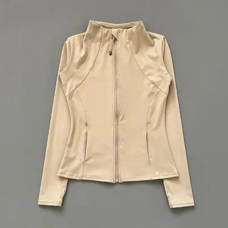 Beige women's zip-up athletic jacket with high collar and side pockets, perfect for fitness and casual wear.