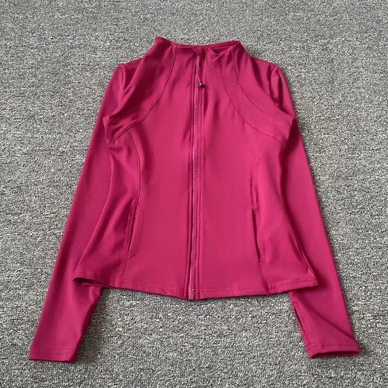 Pink women's athletic zip-up jacket with long sleeves and side pockets, ideal for fitness and casual wear