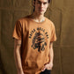 Men's orange graphic tee with 'Raise Hell Eat Tacos' print, casual streetwear style