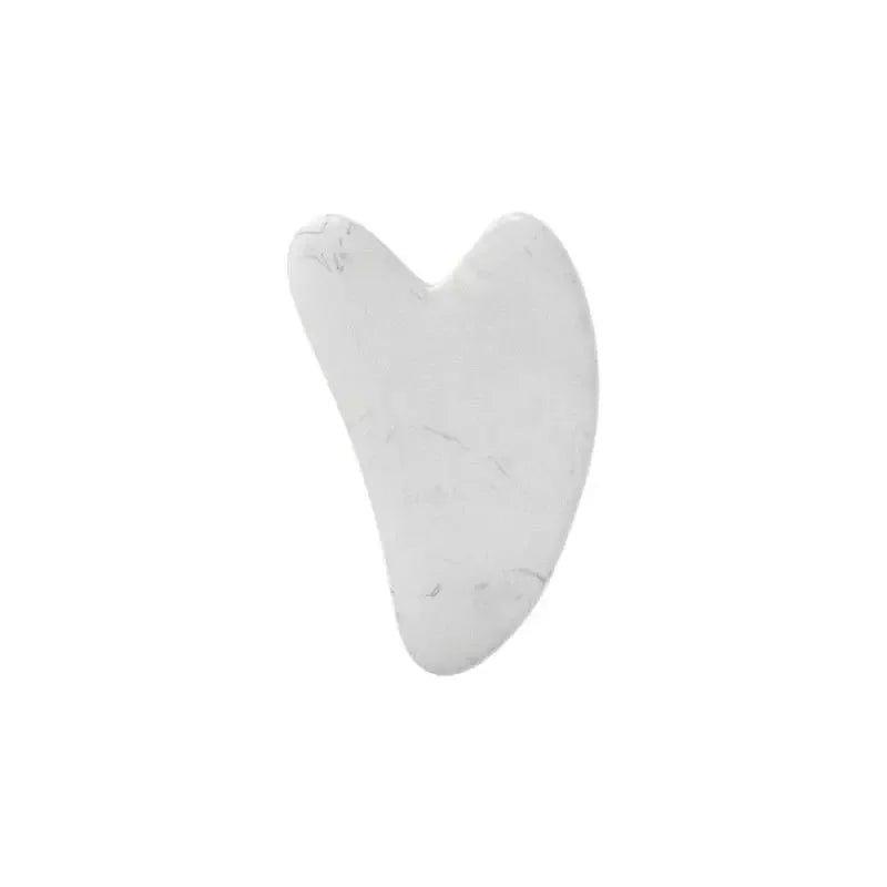 White heart-shaped gua sha tool for facial massage and skincare routine