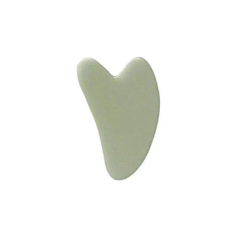 Green jade gua sha tool for facial massage and skincare routine