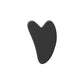 Black heart-shaped gua sha tool for facial massage and skincare routine