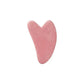 Pink heart-shaped gua sha tool for facial massage and beauty routine