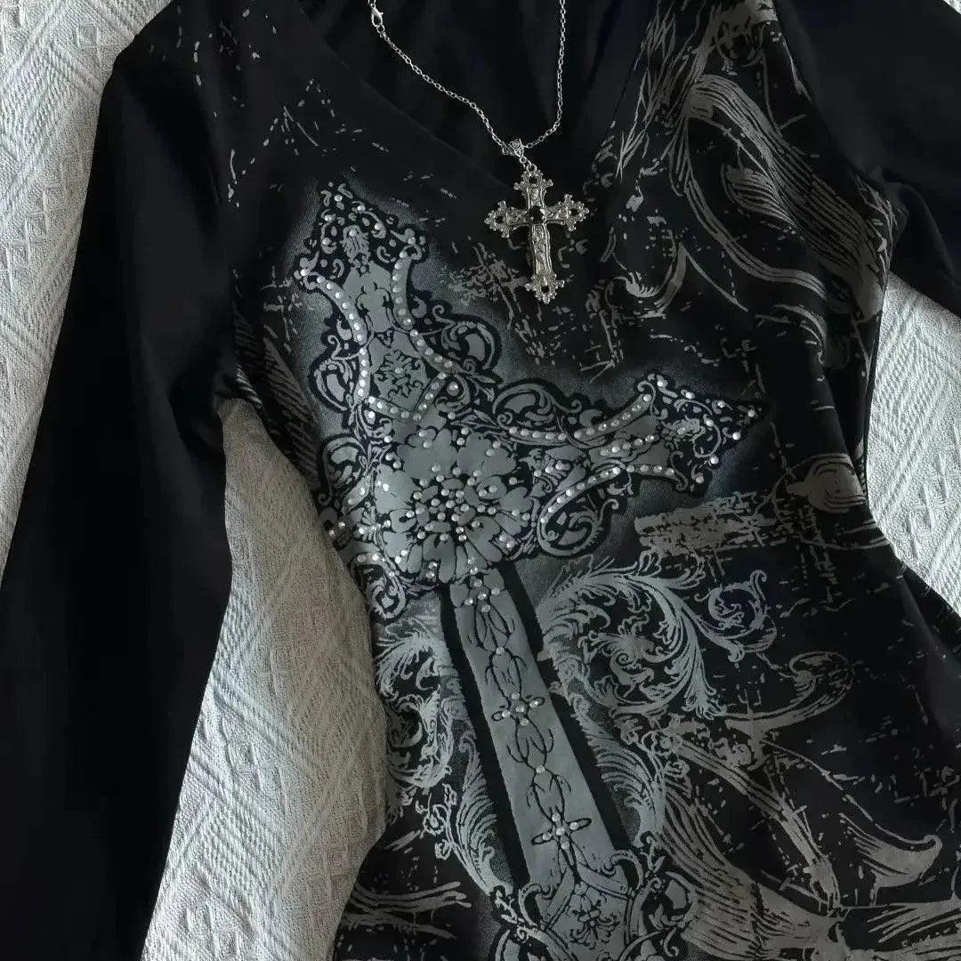 Black gothic dress with silver cross print and rhinestone embellishments, paired with a crystal cross necklace.