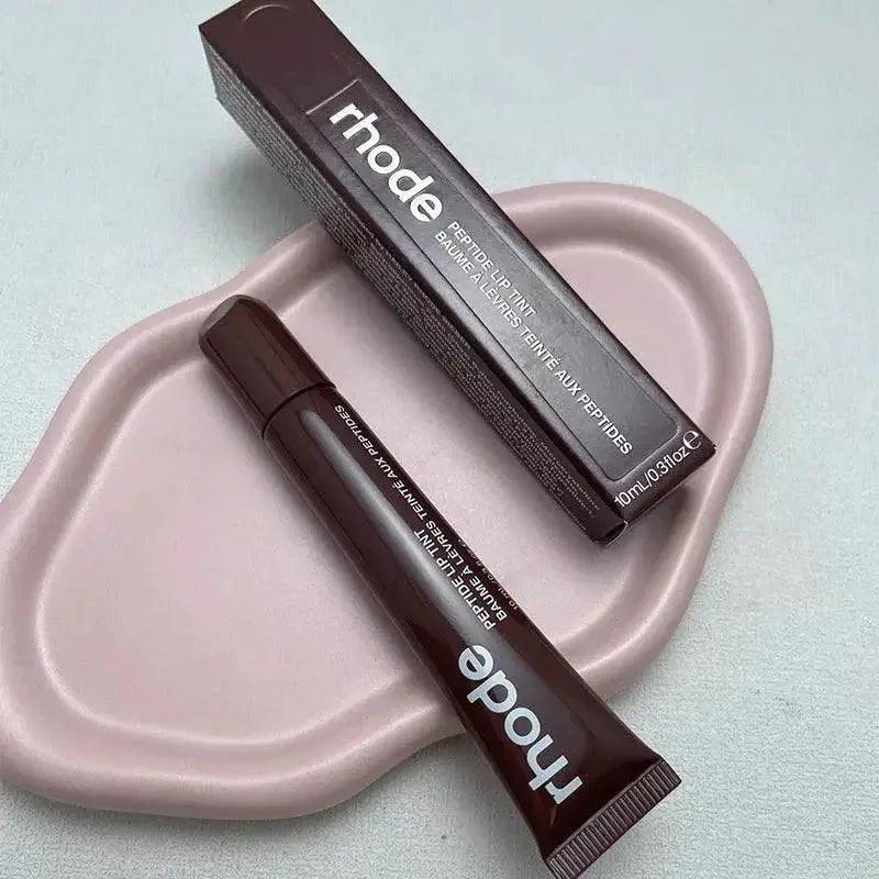 Rhode Peptide Lip Tint in sleek brown tube and box, beauty makeup essential for women's fashion