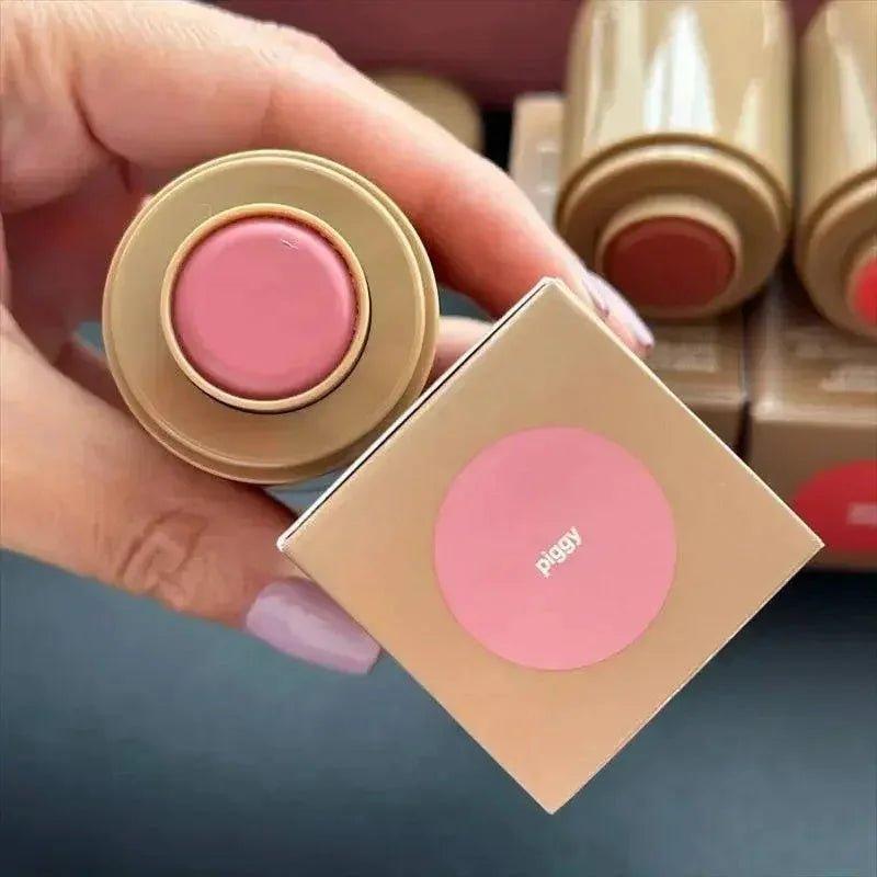 Piggy blush compact with pink shade, held in hand, beauty makeup product