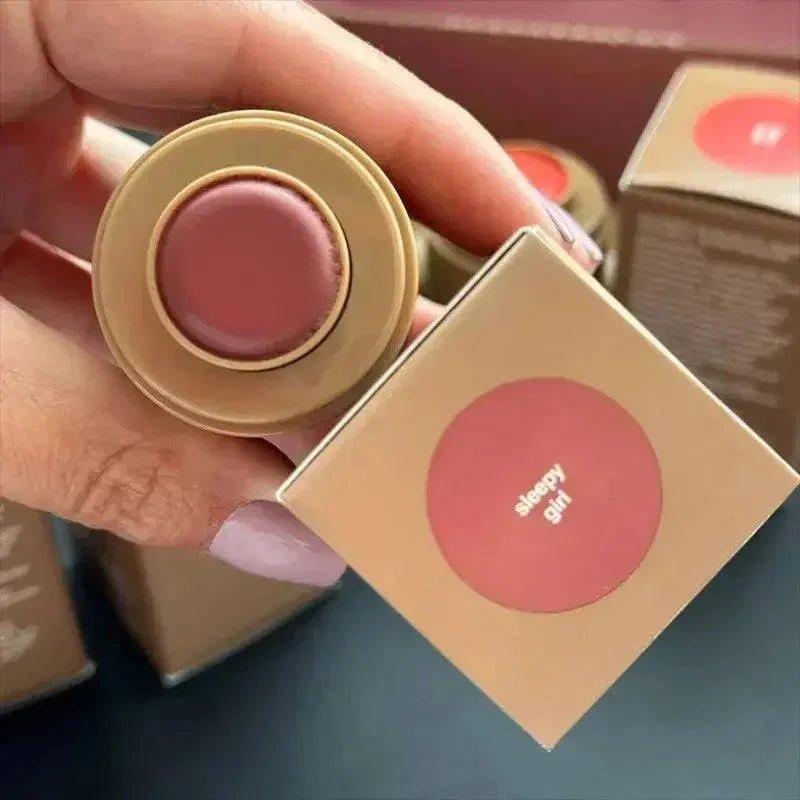Sleepy Girl matte lipstick in nude pink shade, held with gold packaging, beauty makeup product