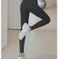 Black high-waist workout leggings with white sneakers, perfect for fitness and yoga sessions