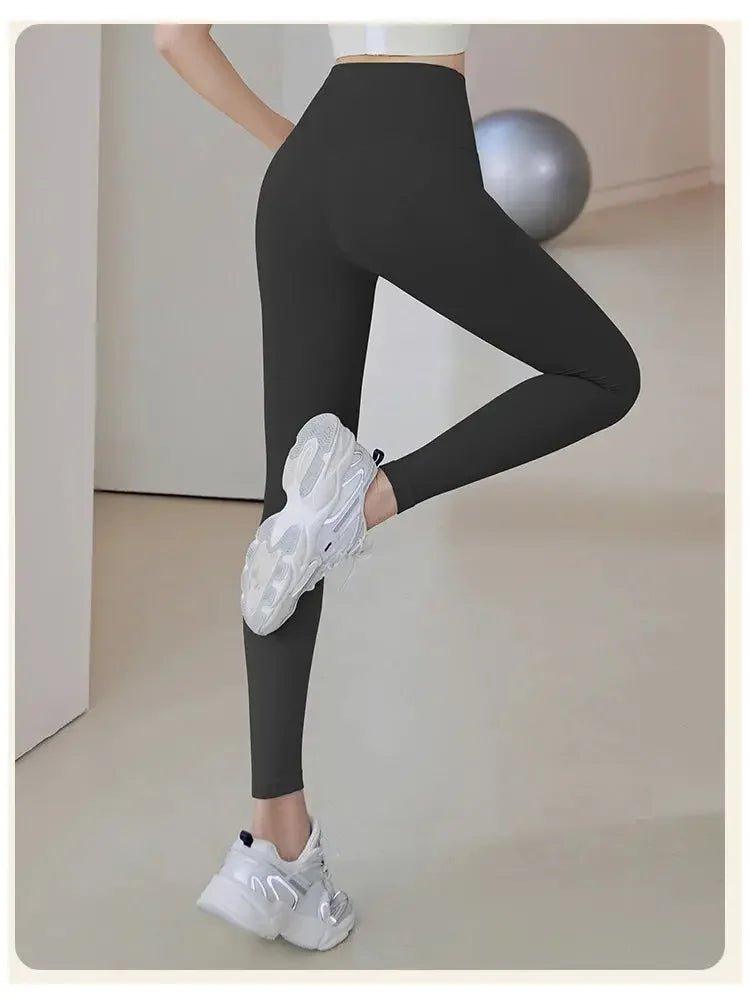 Black high-waist workout leggings with white sneakers, perfect for fitness and yoga sessions