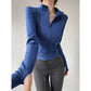 Blue women's long sleeve zip-up athletic jacket with fitted design, paired with gray leggings for workout or casual wear