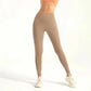 Women's high-waist beige leggings with matching sports bra and white sneakers, fitness fashion