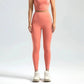 Women's coral pink high-waisted leggings and matching crop top, ideal for fitness and casual wear