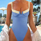 Blue one-piece swimsuit with white straps, high-cut legs, poolside fashion